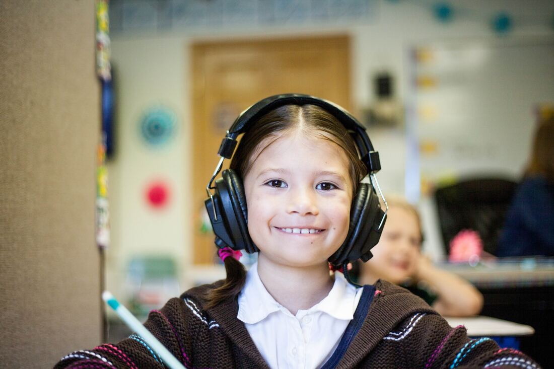 Smiling young girl with headphones