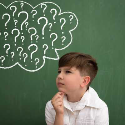 Boy with thought bubble full of question marks