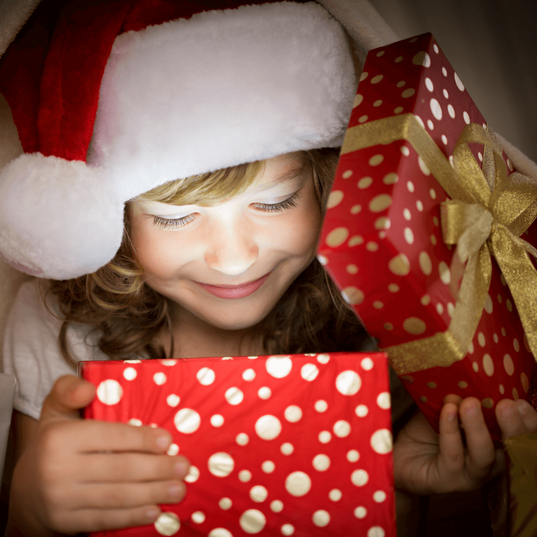 young girl opening christmas gift box